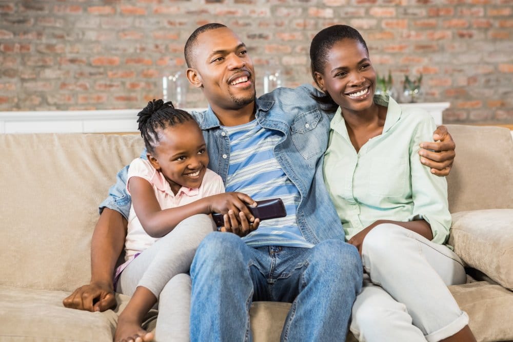 Happy family relaxing on the couch in living room
